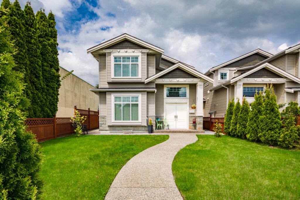 small-family-house-with-curved-concrete-pathway-green-lawn-front-yard